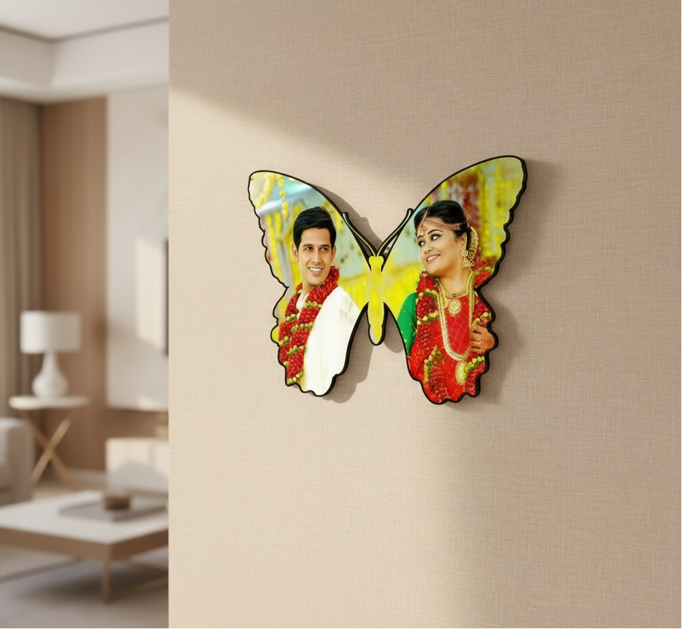 Butterfly-shaped wall mirror with a couple's photo in a living room setting