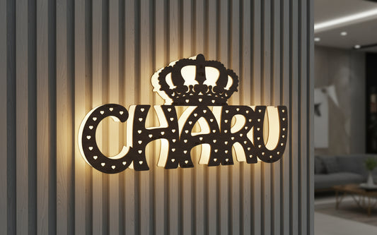 Decorative letters spelling 'CHARU' with a crown on a glass surface.