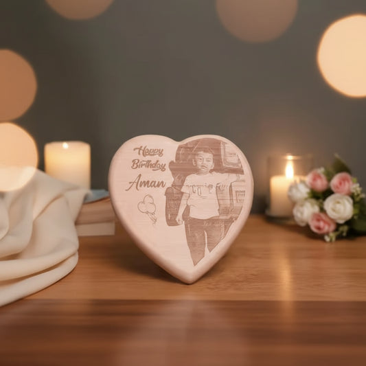Heart-shaped wooden engraving with a photo of a person and 'Happy Birthday Aman' text.