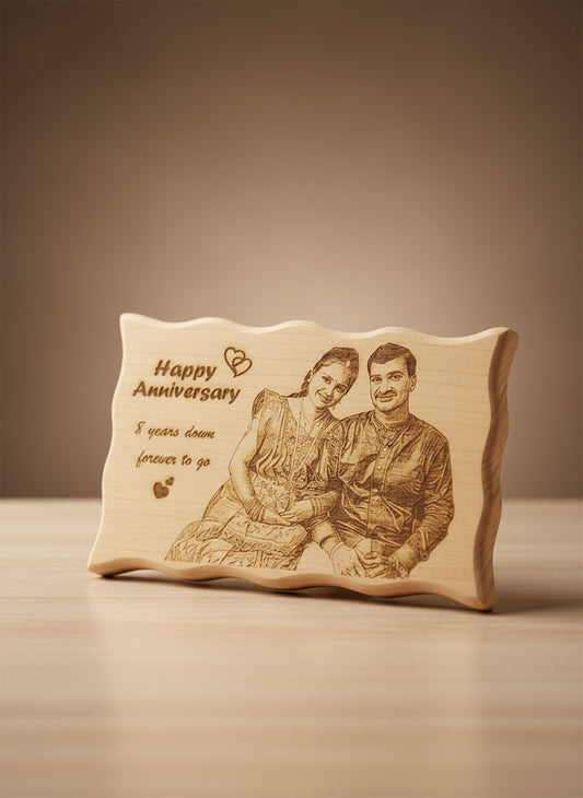 Wooden plaque with engraved couple and 'Happy Anniversary' message in a store setting.