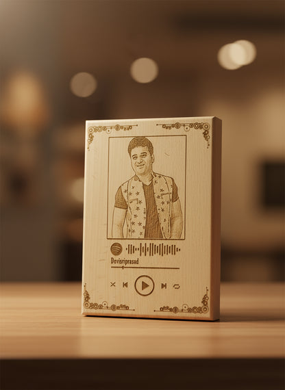 Wooden box with engraved portrait and music player design on a blurred background