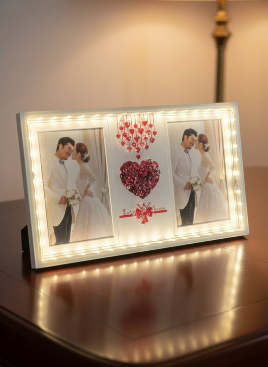 Decorative wall art with a couple kissing, heart design, and string lights on a white background